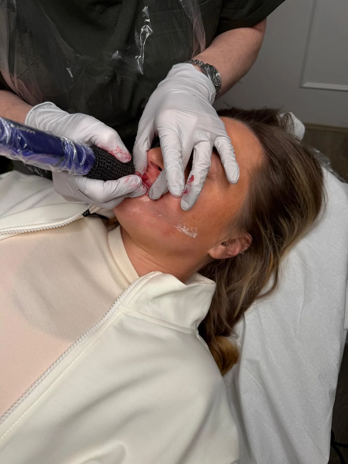 Lip blush pigment being applied during a permanent makeup treatment