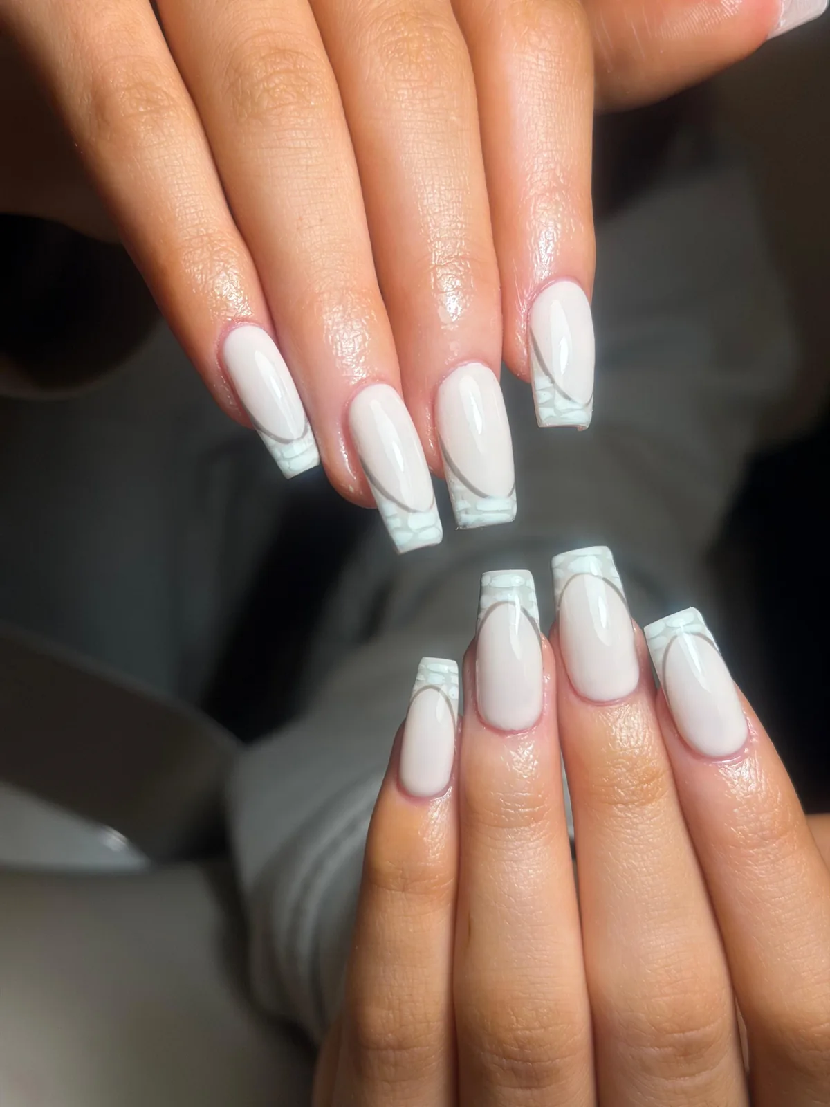 BIAB nails with a milky base and marble French tips, square gloss finish